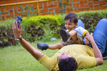 Cute Baby playing with dad ay Pune, Maharashtra.