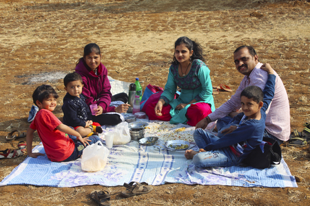 Indian family having breakfast at farm near Tamihini ghat at Puneの写真素材