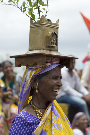PUNE, MAHARASHTRA, INDIA, July 2016, Woman carries a holy basil or tulasi vrindavan during Pandarpur yatraのeditorial素材