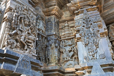 Ornate wall panel reliefs depicting, from left, Narsimha, Sundari, Nagas, Vishnu as Varaha and Lord Bramha Chennakesava temple, Belur, Karnataka, india. View from West.の写真素材
