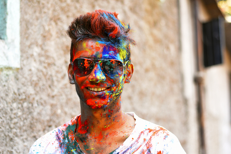 Young man celebrating of Holi festival with colored powder on face, Yerawada Pune, Maharashtra, Indiaの写真素材