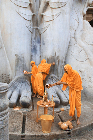 SRAVANABELGOLA, KARNATAKA, MAY 2016, Priests offer worship to gigantic statue of Bahubaliのeditorial素材