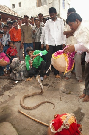 MAHARASHTRA, INDIA, July 2012, People watch show of cobra during Naga Panchami festivalのeditorial素材