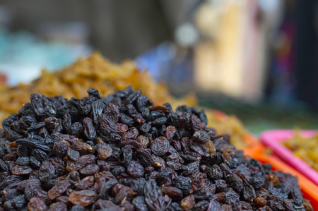 Close up of black dried grapes for sale in local market, Pune Maharashtraの写真素材