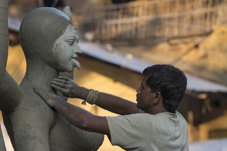 KUMARTULI, KOLKATA, INDIA, October 2014, Artisan working on completion of idolのeditorial素材