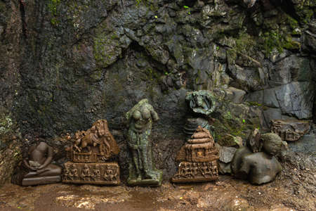 Old abandoned ruined statues of Tirthankar Adinath Jain caves, Tringalwadi fort, Nashik,...