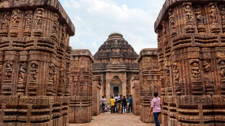 20th Oct 2021 Konark Sun temple, Orissa, India.  Tourist admiring BhogaMandapa or the dance hall. Carvings of  musicians and dancers almost completely cover the platform, walls and pillars of the hallのeditorial素材