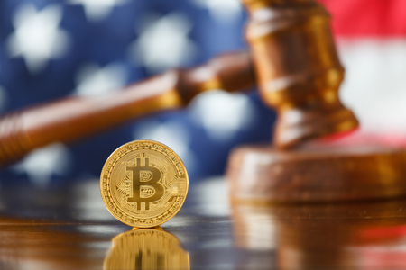 Bitcoin and judge gavel on flag of USA background.の写真素材