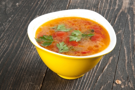 tomato soup in a yellow bowlの写真素材