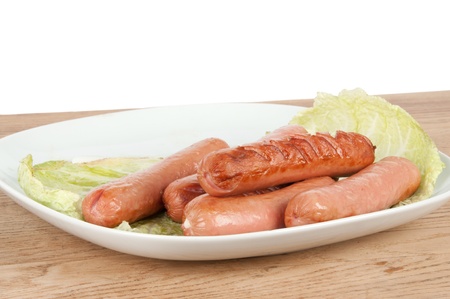 grilled sausages on a plate on the tableの写真素材