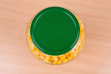yellow corn in a glass jar on the tableの写真素材