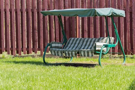 Swing garden on a sunny day in the grassの写真素材