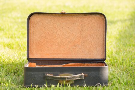 old blue suitcase on grassの写真素材