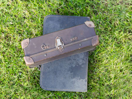 two old suitcase blue and brown on the grassの写真素材
