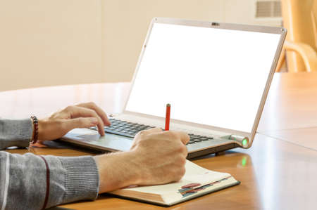 Businessman writing on your calendar at the table
