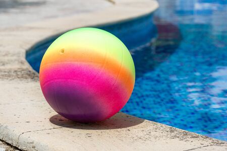 colored ball by the pool in the summerの写真素材