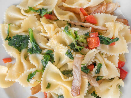 pasta with bacon bell pepper in a white plateの写真素材