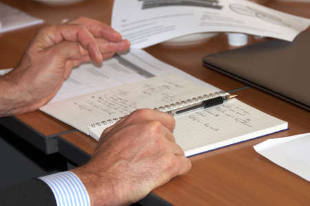 man gesturing at the negotiating tableの写真素材