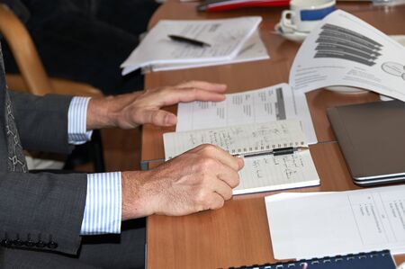 man gesturing at the negotiating table