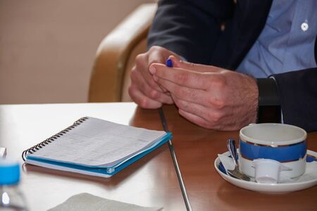 man gesturing at the negotiating table