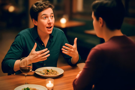 Animated person at restaurant gesturing toward self while companion sits withdrawn with untouched foodの素材