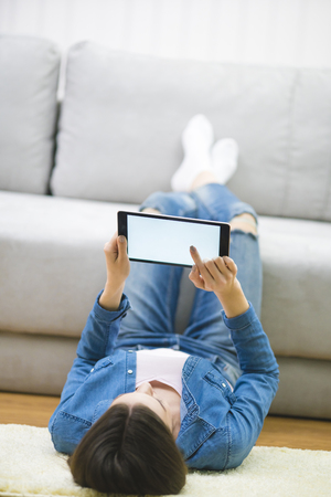 woman with a laptop lay on the floor