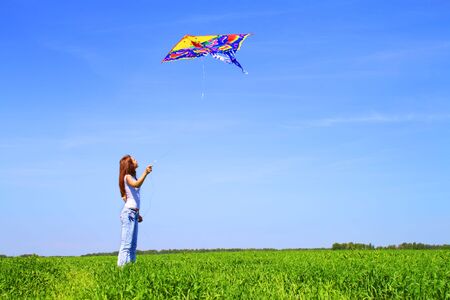 Girl playing with a kiteの写真素材