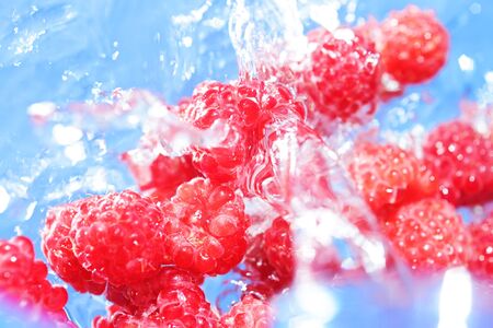 Raspberrieson a blue backgroundの写真素材