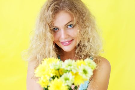 Beautiful girl holding chrysanthemumsの写真素材