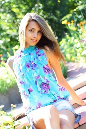 Beautiful girl in a flowered gardenの写真素材