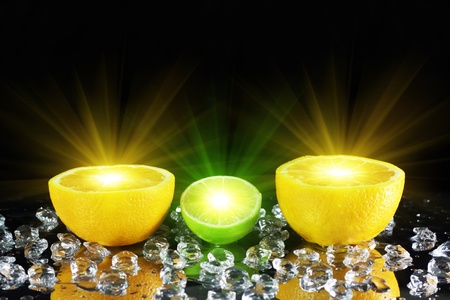 Two orange and lime on a black backgroundの写真素材