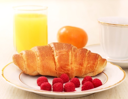 Breakfast. A cup of coffee, croissant, orange juice and berriesの写真素材
