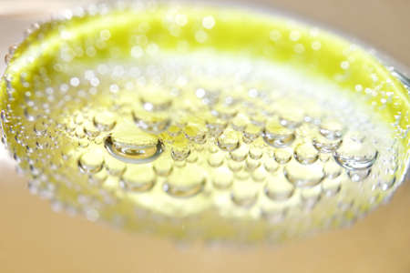 Lemon and drops of carbonated waterの写真素材
