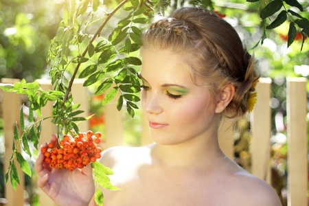 girl with ashberries on a light backgroundの写真素材