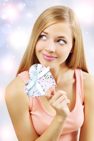 beautiful girl with gift box on light backgroundの写真素材