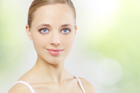 Beautiful girl with clean skin on green backgroundの写真素材