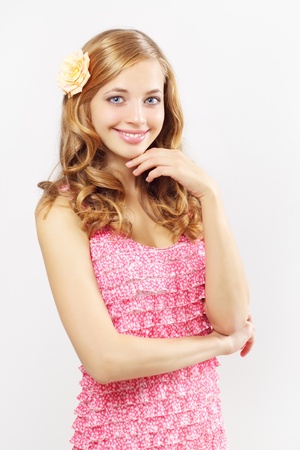 Beautiful girl with long wavy hair on a gray backgroundの写真素材