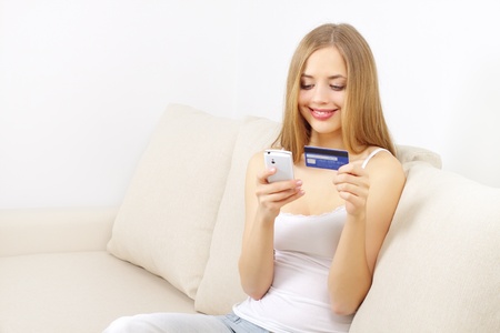 Girl with mobile phone and credit cardの写真素材
