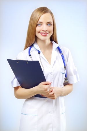 nurse with medical clipboard on a blue backgroundの写真素材