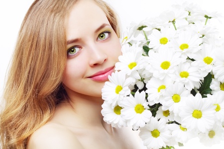 beautiful girl with white chrysanthemum on a light backgroundの写真素材