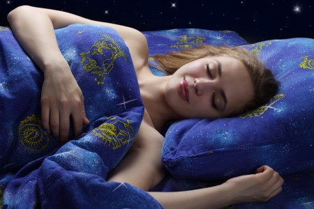 Sleeping Girl at night on dark backgroundの写真素材