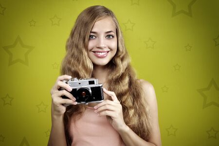 Young girl taking photo with retro camera