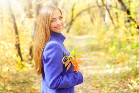 Portrait of a beautiful girl in autumn forestの写真素材