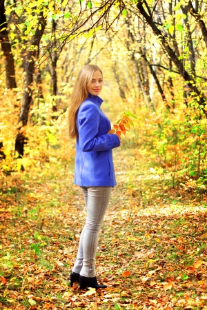 Portrait of a beautiful girl in autumn forestの写真素材