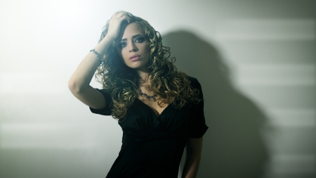 Portrait of a beautiful girl with curly hairの写真素材