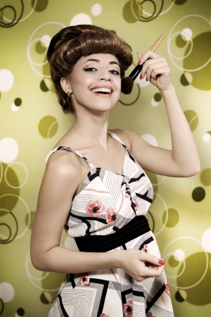 Retro style  Beautiful girl with makeup brushの写真素材