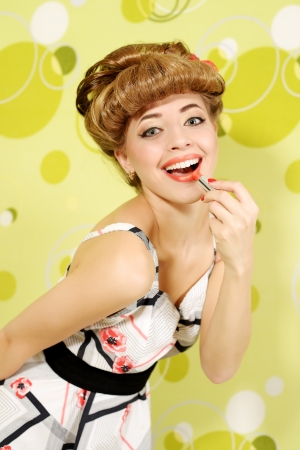 Pin-up girl with lipstick on light backgroundの写真素材