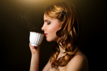 An attractive girl with a cup of coffeeの写真素材