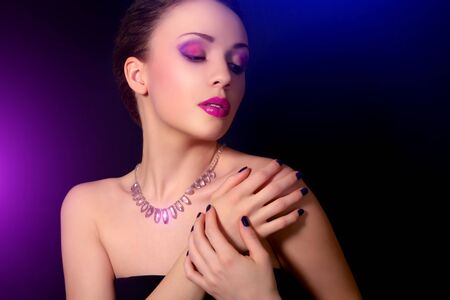 Beautiful woman with blue nails and creative makeupの写真素材