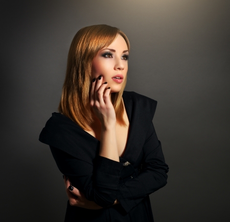 Stylish girl with beautiful makeup on black backgroundの写真素材